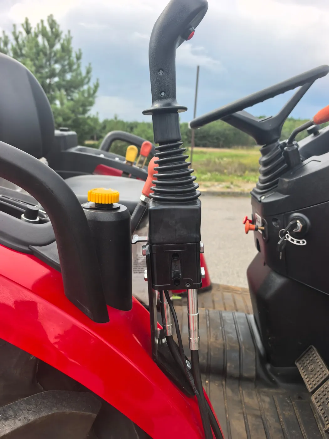Joystick. Loader and bucket run from a single joystick.